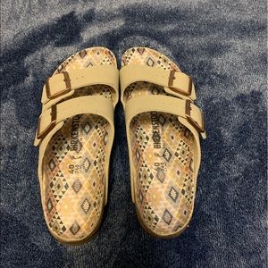 Tan geometric patterned birkenstocks.